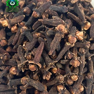 May include: A close-up image of a pile of dried cloves. The cloves are dark brown and have a slightly wrinkled texture.