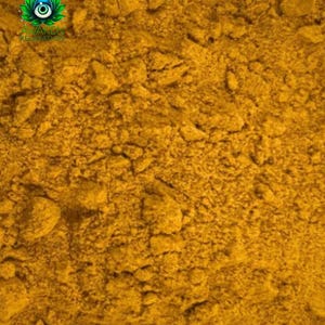 May include: Close-up of a pile of bright yellow turmeric powder.