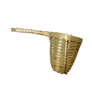 May include: A natural bamboo tea infuser with a long handle. The infuser is woven with a basket-like design.