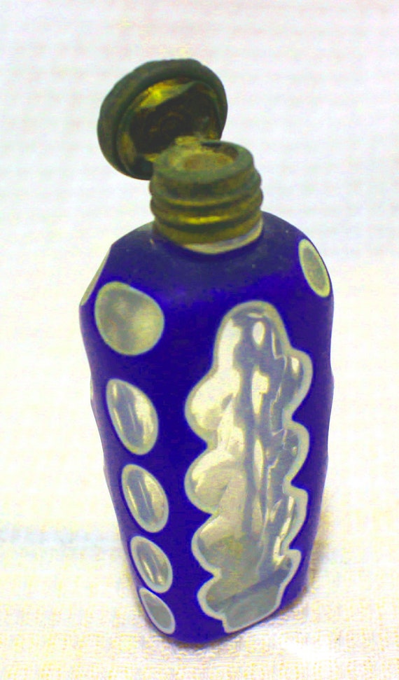 Antique glass perfume bottle. Cut to clear over bl