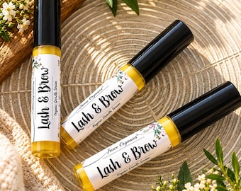 May include: Three cylindrical tubes of Trove Organics Lash & Brow Organic Growth Serum with black caps and yellow liquid contents. Each white label features floral illustrations and the text Lash & Brow Organic Growth Serum.