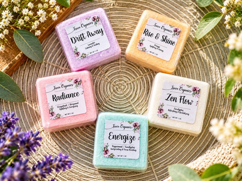 May include: Five square bath bombs in purple, orange, pink, light blue, and white. Each features a Treve Organics label with names Drift Away, Rise & Shine, Radiance, Energize, and Zen Flow, plus scent notes and a net weight of 28g.
