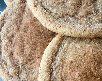 May include: Close-up of four brown sugar cookies, dusted with sugar crystals, on a wire rack.