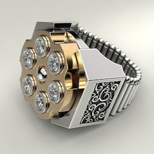 May include: A silver and gold ring with a revolver-shaped design. The revolver has six diamond-shaped stones set in the cylinder. The band of the ring is made of linked silver pieces.