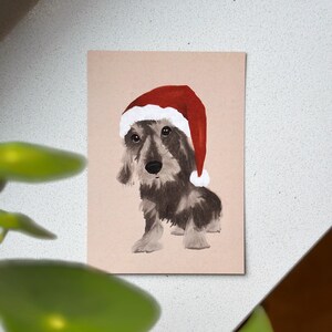 Cartolina di Natale “Bassotto di Natale”. Bassotto. Natale . Cappello di Babbo Natale. cani salsiccia. dolce . Carino . cane