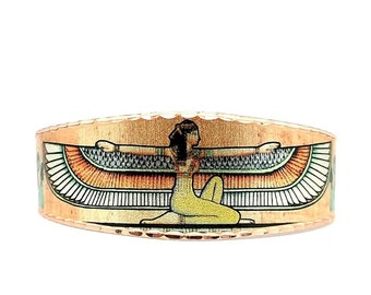 May include: Copper ring with an image of the Egyptian goddess Isis with outstretched wings. The ring is a warm copper color with a textured surface.