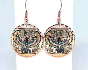 May include: A pair of copper earrings with a round, textured design. Each earring features a colorful image of an Egyptian goddess with outstretched wings, surrounded by hieroglyphs.