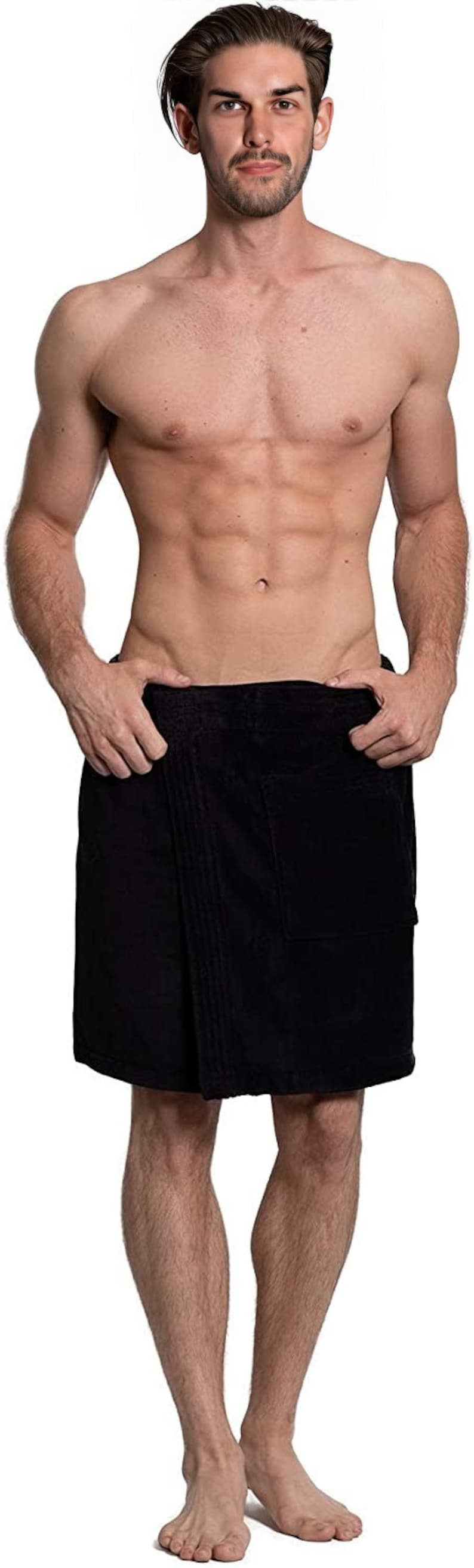 May include: A solid black wrap-around towel featuring a textured fabric surface, a straight hemline, and a large square patch pocket on the front right side. The towel is secured at the waist with a simple overlapping design and a clean finish.