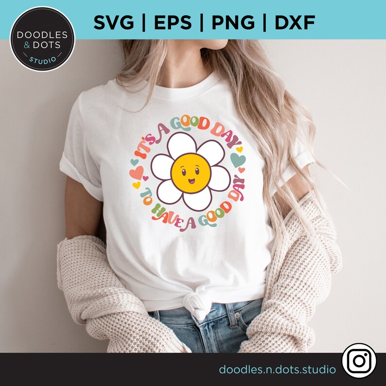May include: White t-shirt with a colorful daisy graphic and the text "It's a good day to have a good day".