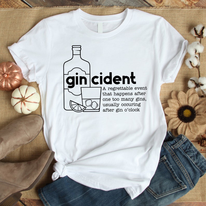 May include: White t-shirt with a black graphic of a bottle of gin, a glass of gin, a lime wedge, and ice cubes. The text "gincident" is written in black above the graphic. The text below the graphic reads: "A regrettable event that happens after one too many gins, usually occurring after gin o'clock."