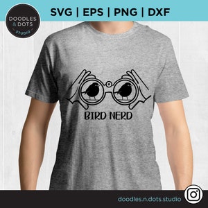 May include: A gray t-shirt with a black design of two hands holding binoculars with birds inside. The text "BIRD NERD" is below the binoculars.