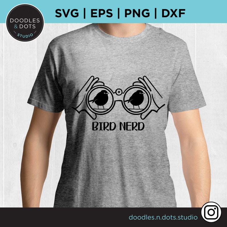 May include: A gray t-shirt with a black design of two hands holding binoculars with birds inside. The text "BIRD NERD" is below the binoculars.