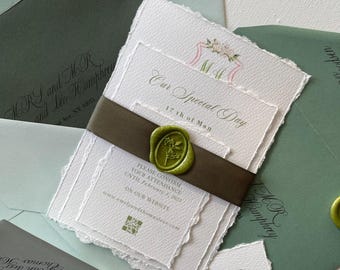 May include: A wedding invitation suite in a green and white colour scheme. The invitation features a wax seal with a floral design and the text "Our Special Day 17th of May". The RSVP card includes the text "Please confirm your attendance until 1st February 2025 on our website www.emilyandthomaslove.com".