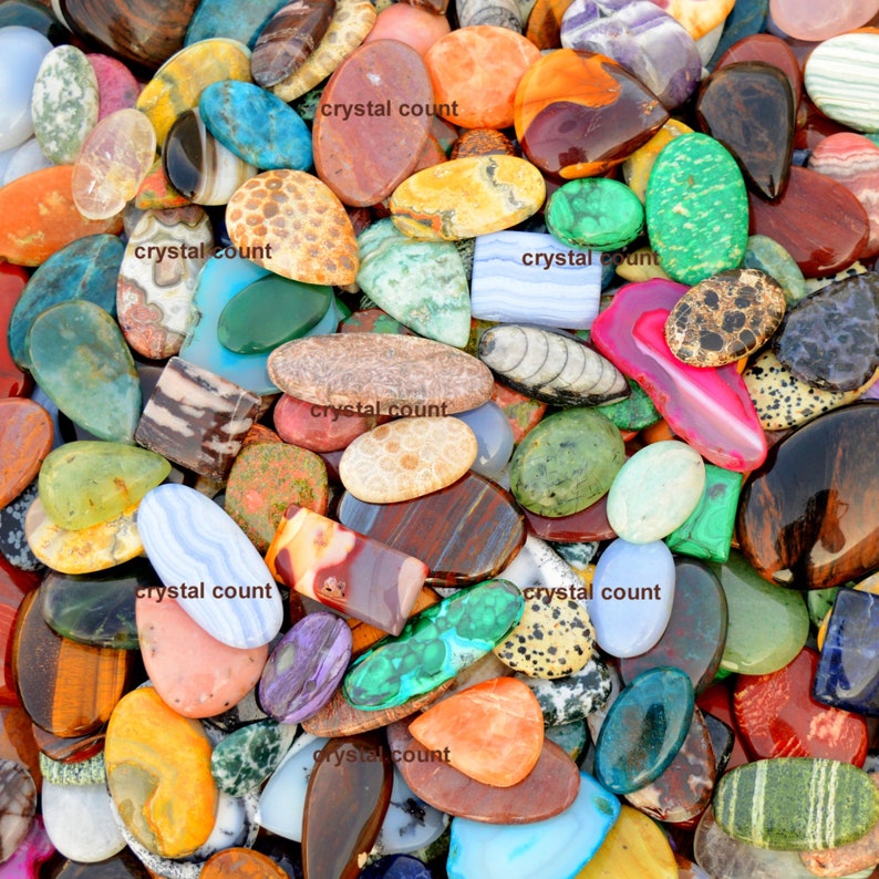 May include: A large collection of colourful, polished, and smooth natural stones. The stones are various shapes and sizes, and some have unique patterns.