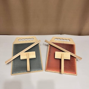 May include: Two wooden wool carding tools with a wooden handle, a wooden brush, and two wooden sticks. One tool has a blue and gray carding surface and the other has a red and orange carding surface.