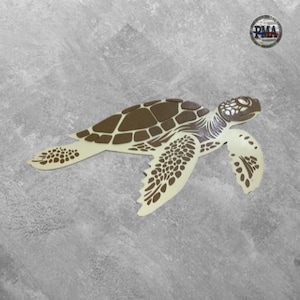 May include: A brown and white sea turtle cutout with a detailed shell design. The turtle is facing right and has a long neck and tail.