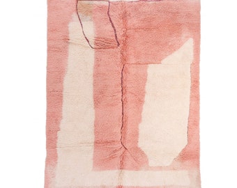 Könnte beinhalten: Ein rosa-weißer marokkanischer Teppich mit geometrischem Muster. Der Teppich hat einen Fransenrand.