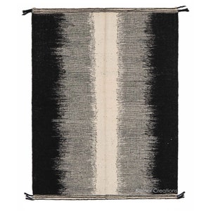 May include: Black and white handwoven rug with a vertical white stripe in the centre. The rug has a gradient pattern, fading from black to white.
