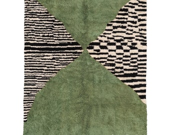 May include: A green, black, and white Moroccan rug with a geometric pattern. The rug has a fringe border and the text "Berber Creations" is visible in the bottom right corner.