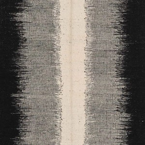 May include: A black and white abstract textile with a vertical white stripe down the centre. The textile has a woven texture.