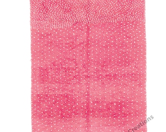 May include: A pink and white Moroccan rug with a subtle pattern. The rug has a fringed edge.