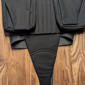 May include: Black fabric tool belt with multiple pockets and a padded waist strap.