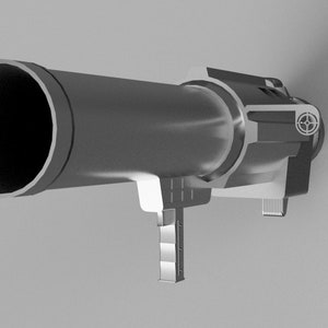 Könnte beinhalten: Ein silberfarbener Raketenwerfer mit einem schwarzen Lauf und einem Visier oben. Der Werfer hat einen Griff an der Seite und einen Abzug unten.