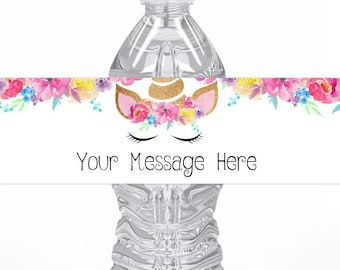 May include: Water bottle label with a unicorn face and floral design. The label has the text "Your Message Here".