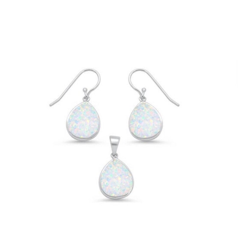 May include: A set of silver earrings and a pendant featuring white opal teardrop-shaped stones.