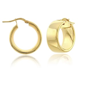 May include: A pair of gold hoop earrings. The earrings are a classic design with a rounded, flat front. The gold has a polished, reflective surface. The earrings are shown against a white background.