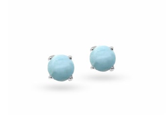 May include: A pair of silver stud earrings with light blue round gemstones.