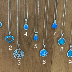 May include: Nine silver necklaces with blue opal pendants. The pendants feature different designs, including a circle, heart, tree, teardrop, star, and starfish.