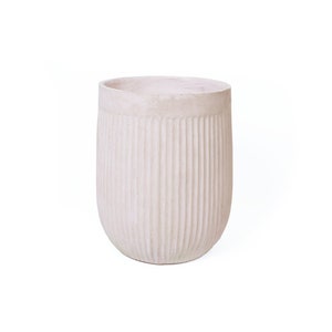 May include: A white ceramic planter with a ribbed texture. The planter is round and has a wide opening.