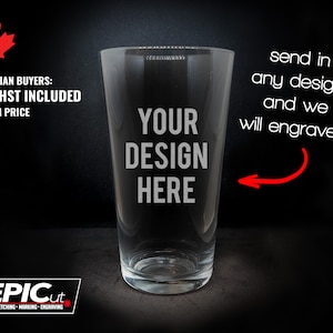 May include: A clear glass pint glass with the text "YOUR DESIGN HERE" engraved on the front. The text "send in any design and we will engrave it!" is written in white text on a black background.