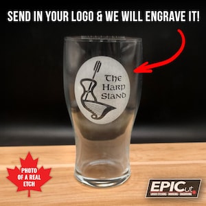 May include: A clear glass pint glass with a laser etched design of a harp and the text "The Harp Stand".