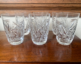 May include: Set of six clear glass tumblers with a cut glass design. The glasses have a starburst pattern.