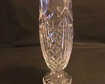 May include: A clear glass vase with a cut crystal design. The vase has a wide mouth and a flared base.