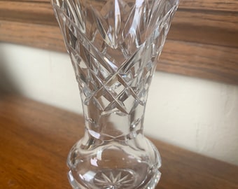 May include: A clear glass vase with a cut crystal design. The vase has a wide mouth and a narrow base.
