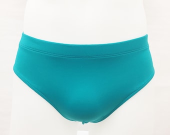 May include: Teal blue swim trunks with a simple design.