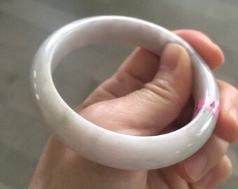 May include: A white jade bangle bracelet with a subtle green hue.