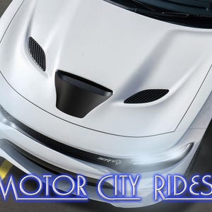 May include: A white car with a black hood scoop and vents. The front of the car has a sleek design with the text "MOTOR CITY RIDES" in blue and white.
