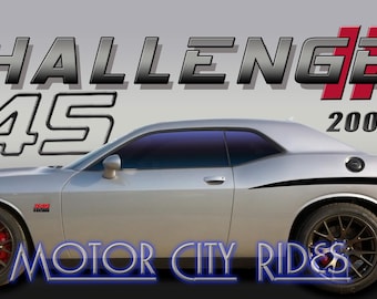 May include: A silver Dodge Challenger 345 with black racing stripes and black wheels. The car has a black and red "CHALLENGER" logo and the text "2008-2023" on the back. The car is parked on a gray surface. The text "MOTOR CITY RIDES" is visible in the bottom of the image.