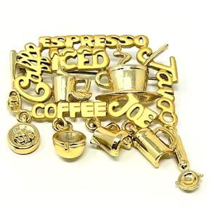 May include: Gold-toned coffee-themed brooch with the words "Espresso," "Iced," and "Coffee." The brooch features miniature coffee cups, a coffee pot, and other coffee-related charms. The word "Tango Joe" is also included.