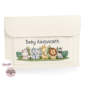 May include: A cream-colored fabric folder with a flap closure. The front features a personalized name "Baby Ainsworth" and a colorful illustration of jungle animals including a giraffe, zebra, lion, elephant, and hippopotamus.