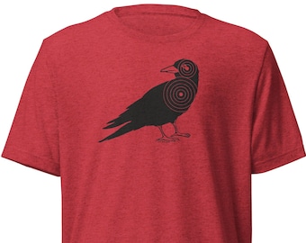 May include: Red heather t-shirt with a black silhouette of a crow with bullseye targets on its body.