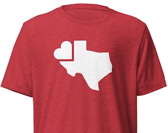 May include: Red t-shirt with a white outline of the state of Texas with a heart in the top left corner.
