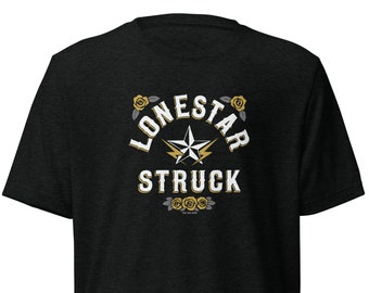 May include: Black t-shirt with a white graphic of a star with lightning bolts and the text "Lone Star Struck" in a gold and white font.