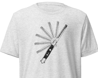 May include: A gray t-shirt with a black and white illustration of a multi-blade pocket comb.