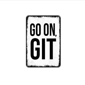 May include: A rectangular metal sign with a white background and black distressed edges. The sign features the bold black text "GO ON, GIT" centered in a sans-serif font. The overall appearance of the sign is weathered and aged with a worn texture.