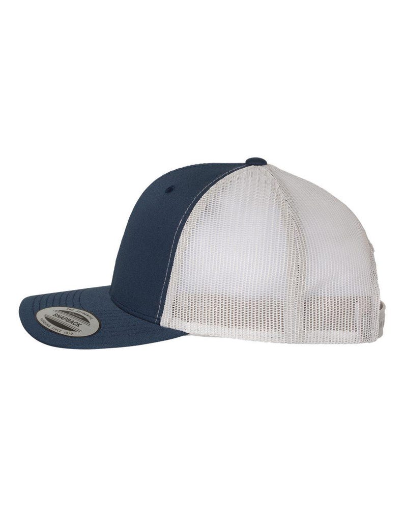 May include: A navy blue and white trucker hat. The front panels and brim are navy blue, while the back is white mesh. The hat has a curved brim and a snapback closure. The hat has a small, circular logo on the front.
